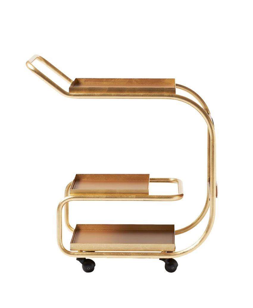 A gold metal bar cart with a modern curved frame, featuring two brown shelves and four small black wheels, shown in profile against a white background.