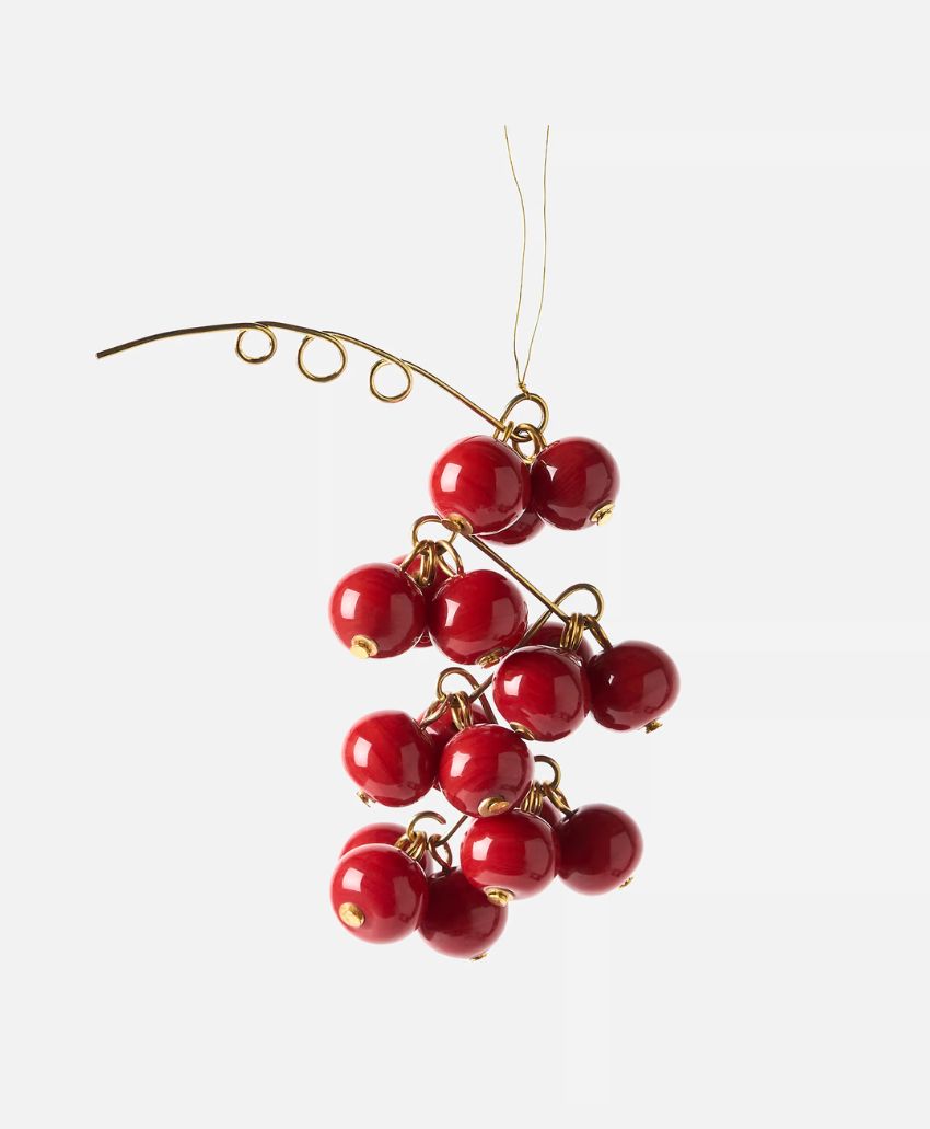 A cluster of shiny red bead-like ornaments arranged to resemble berries, connected by thin gold wire against a plain white background.