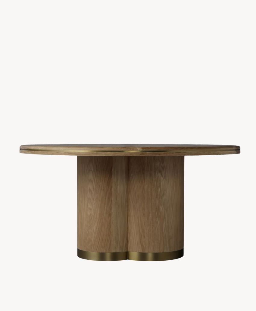 Round wooden table with a thick, smooth top and a sturdy double-pedestal base, featuring brass accents at the bottom. The design is modern and minimalist, set against a plain white background.
