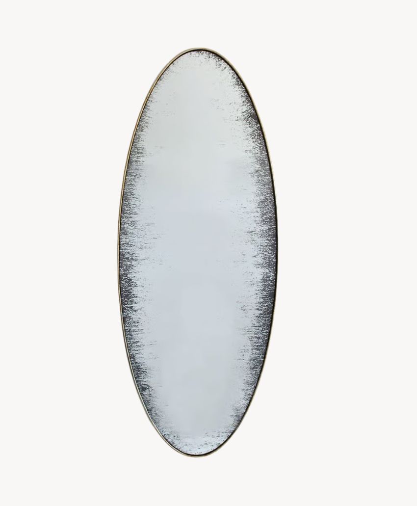 An oval-shaped mirror with a distressed, darkened edge, creating a vintage or weathered look against a plain white background.
