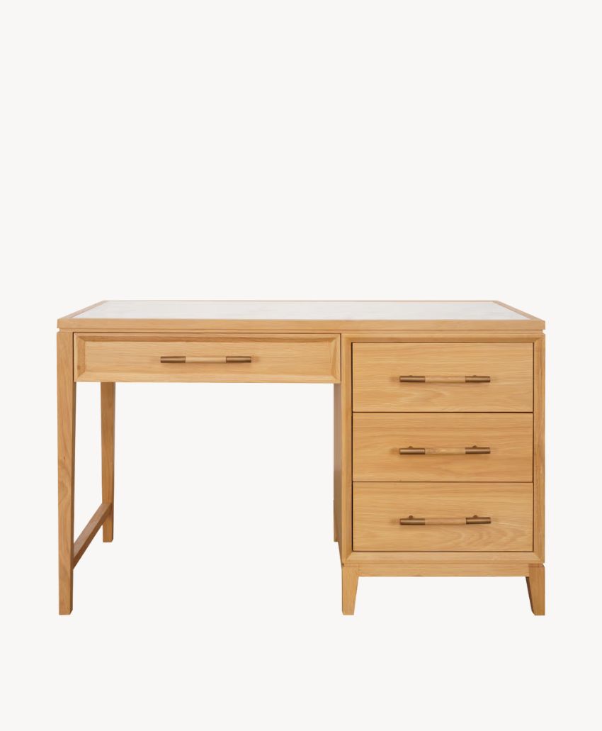 A wooden desk with a natural finish, featuring one central drawer and three stacked drawers on the right side, all with matching handles, set against a plain white background.