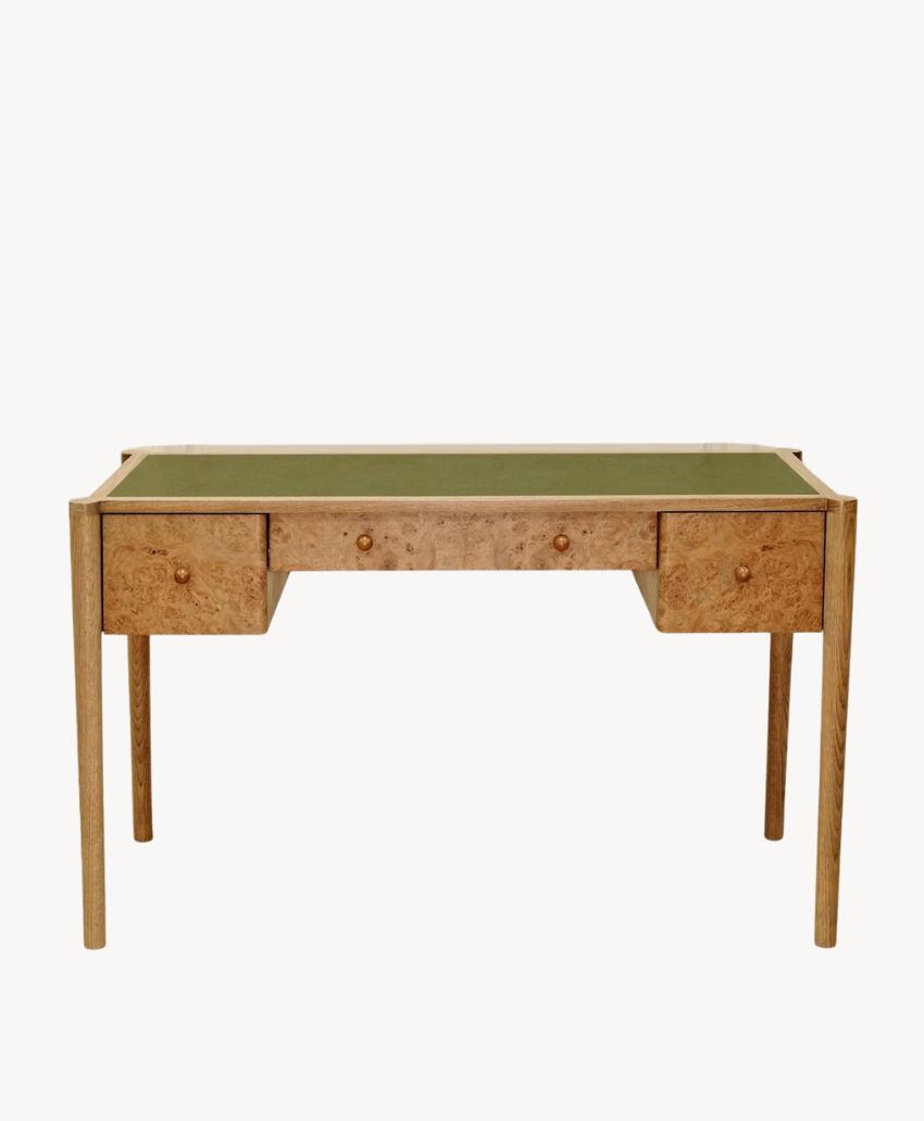 A wooden desk with a green tabletop and three drawers, featuring simple, straight legs and a minimalist design, photographed against a plain white background.