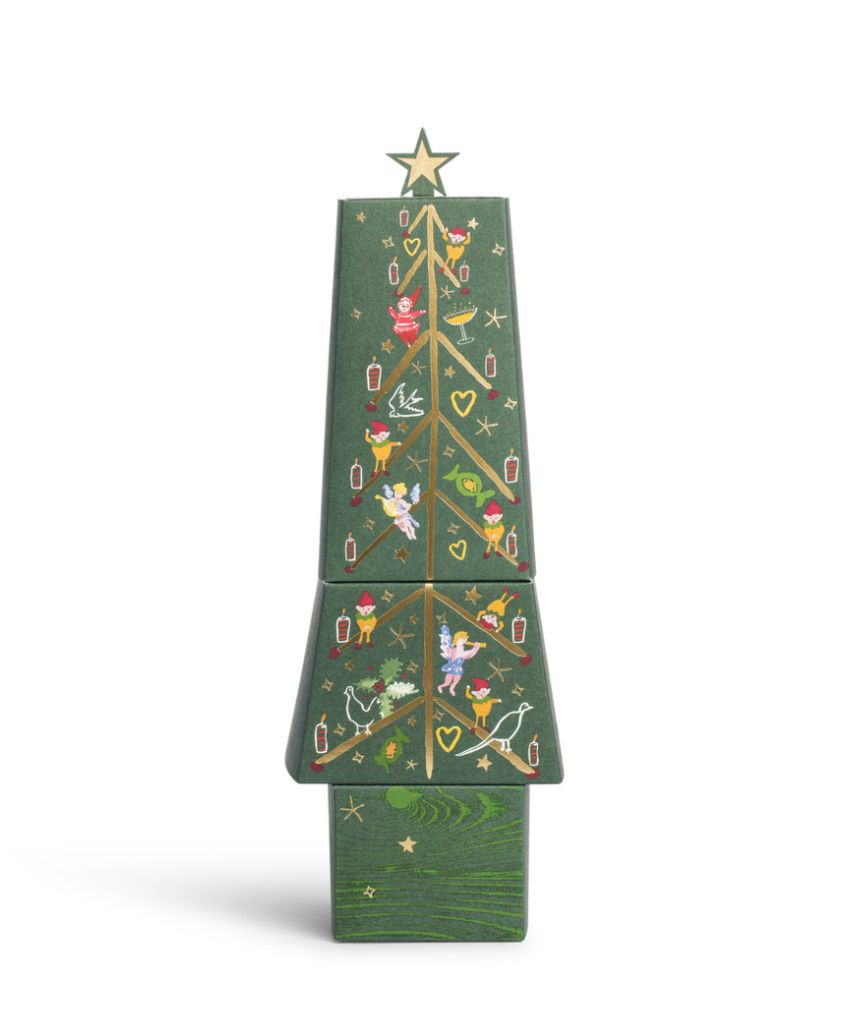 A wooden, block-style Christmas tree with a star on top, decorated with painted ornaments, candy canes, hearts, and holly on a green background. The tree is divided into three stacked sections.