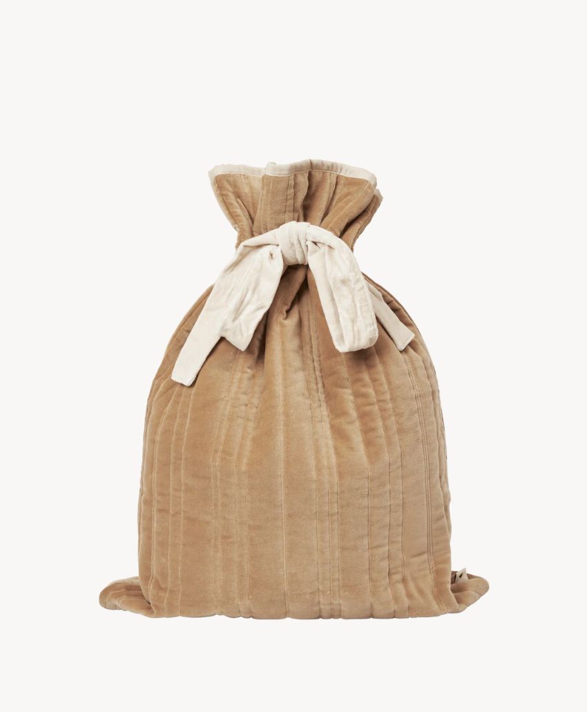A beige, quilted fabric drawstring bag with cream-colored ties, standing upright against a plain white background.