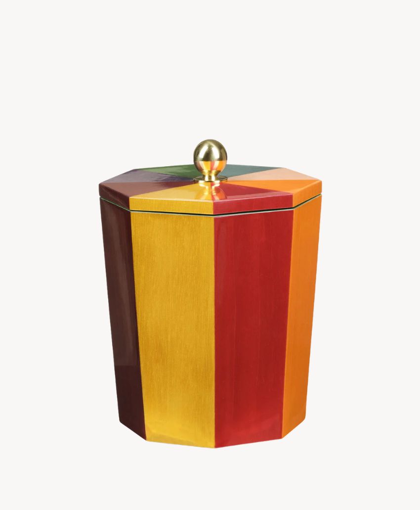 Octagonal container with vertical red, yellow, and orange stripes, featuring a gold knob on its lid, set against a plain white background.