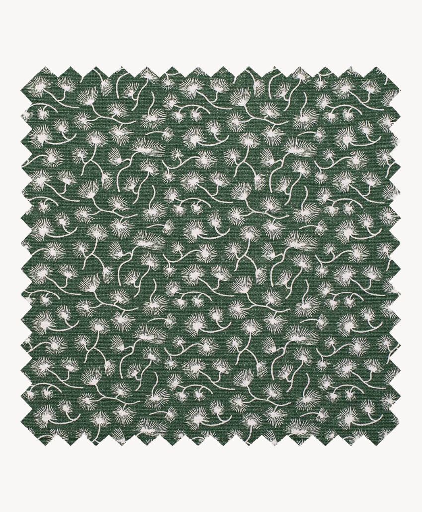 A square swatch of dark green fabric featuring a repeating pattern of small, white, stylized flowers with thin, curving stems and leaves. The edges of the fabric are zigzag cut.