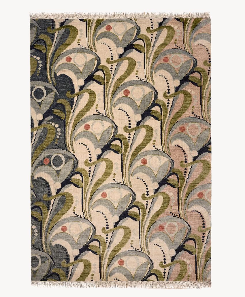 Rectangular rug with an abstract, repeating floral pattern in muted shades of green, cream, gray, beige, and pink. The design features curved leaves, dots, and fan-like shapes, with fringed edges on the shorter sides.