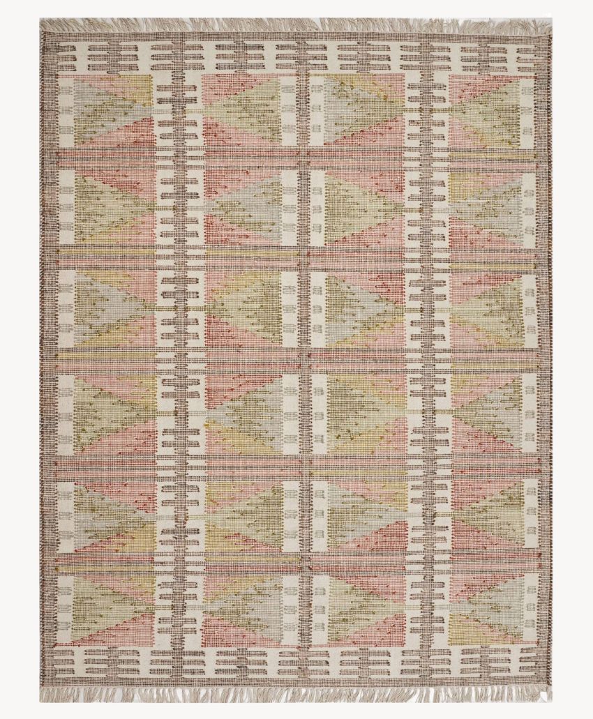Geometric patterned rug featuring repeating triangular shapes in muted pink, green, and beige tones, with a border of vertical dashed lines and fringe on the shorter edges.