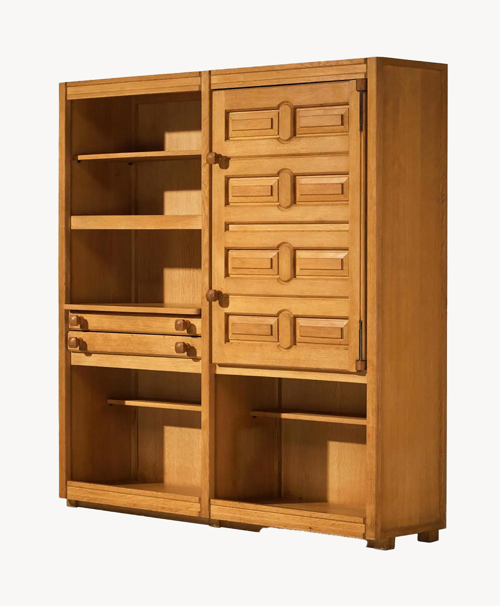 A wooden cabinet with open shelves on the left, two drawers, and a section with a door featuring geometric patterns and four small knobs on the right. The cabinet has a natural wood finish.