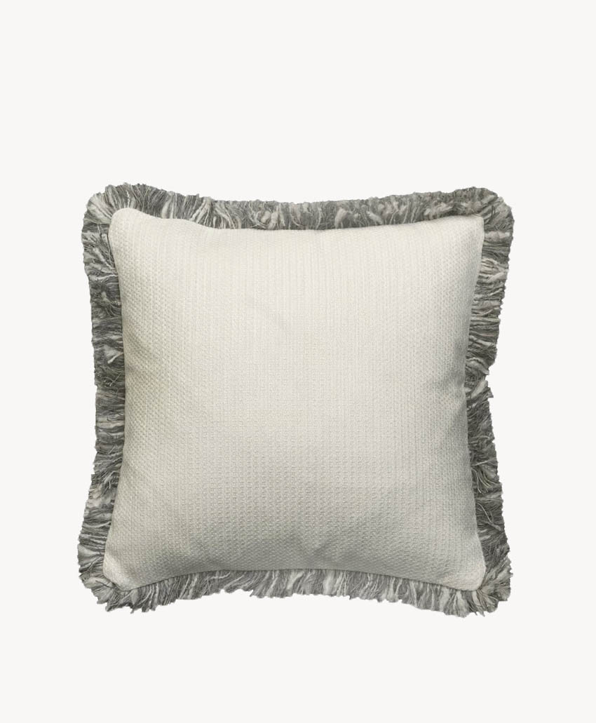 Square white pillow with a subtle textured pattern, featuring gray fringe trim along the edges, set against a plain white background.