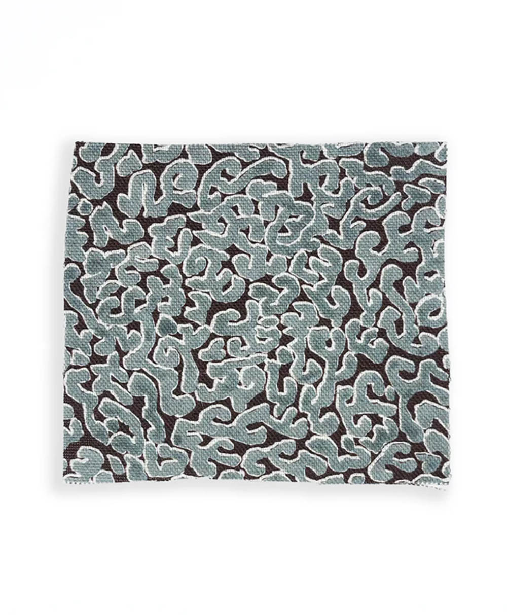 A square fabric with an abstract, wavy pattern in light blue and white on a black background, resembling a maze or coral design.