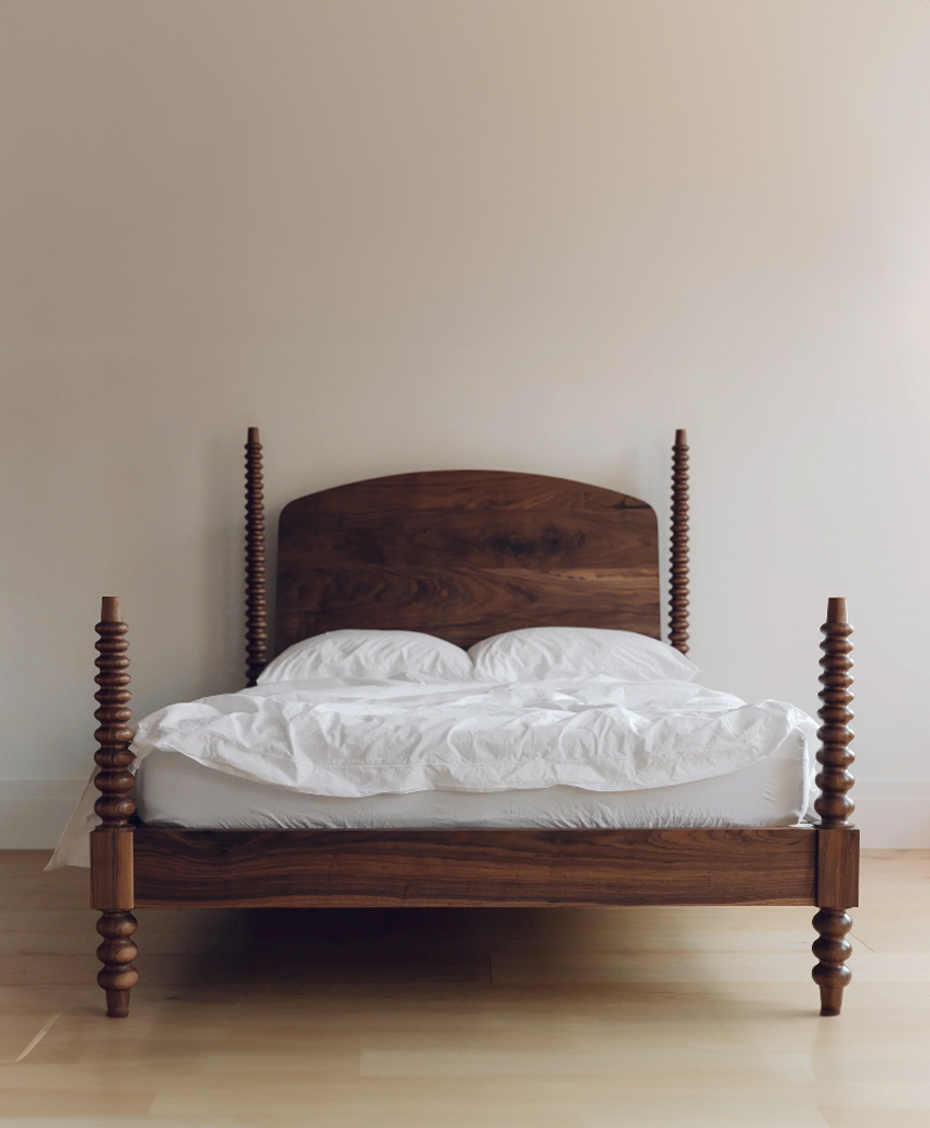 A bed with white sheets and pillows.