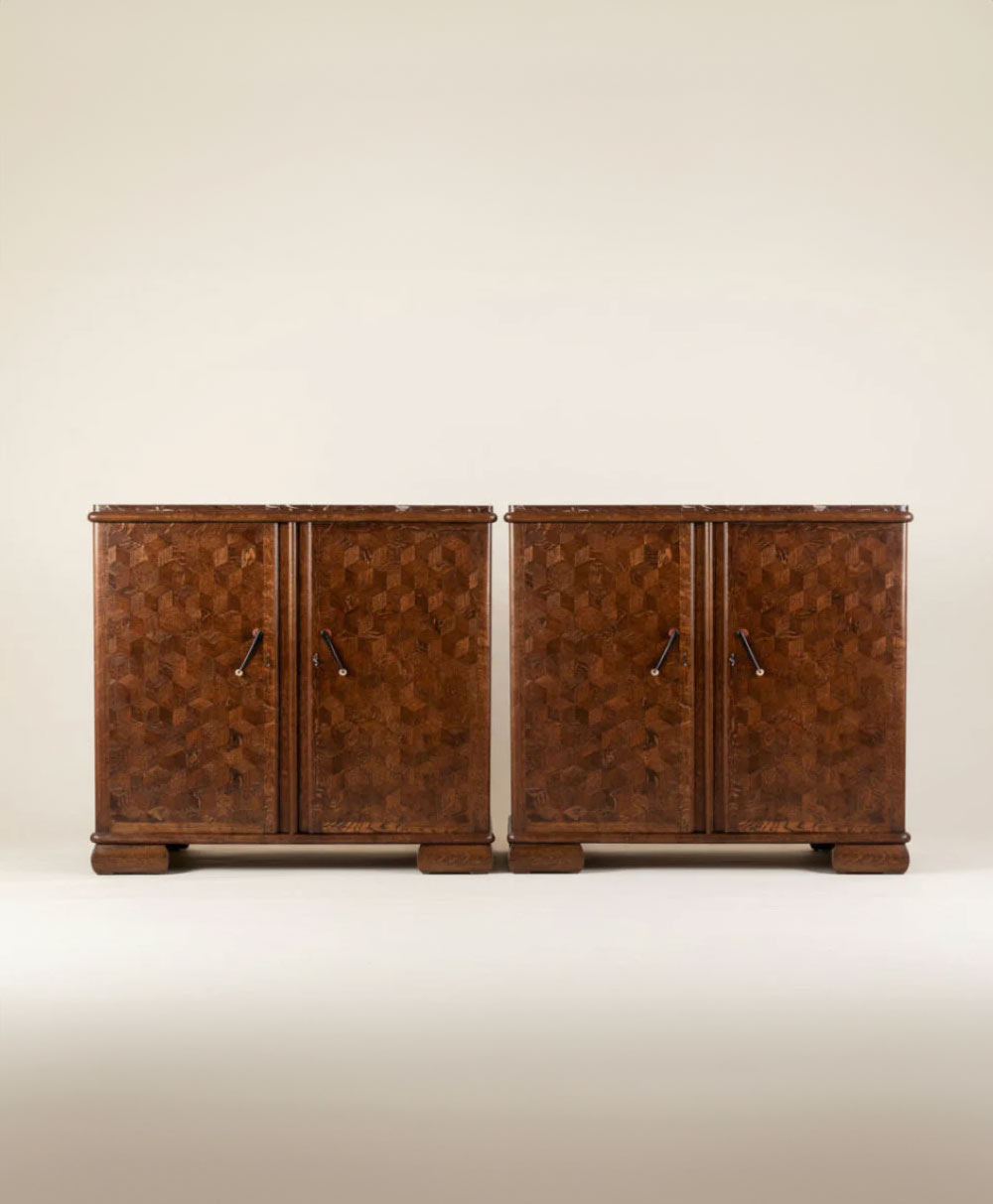 Pair of vintage wooden cabinets with geometric patterned doors and dark handles, standing side by side against a plain light background.