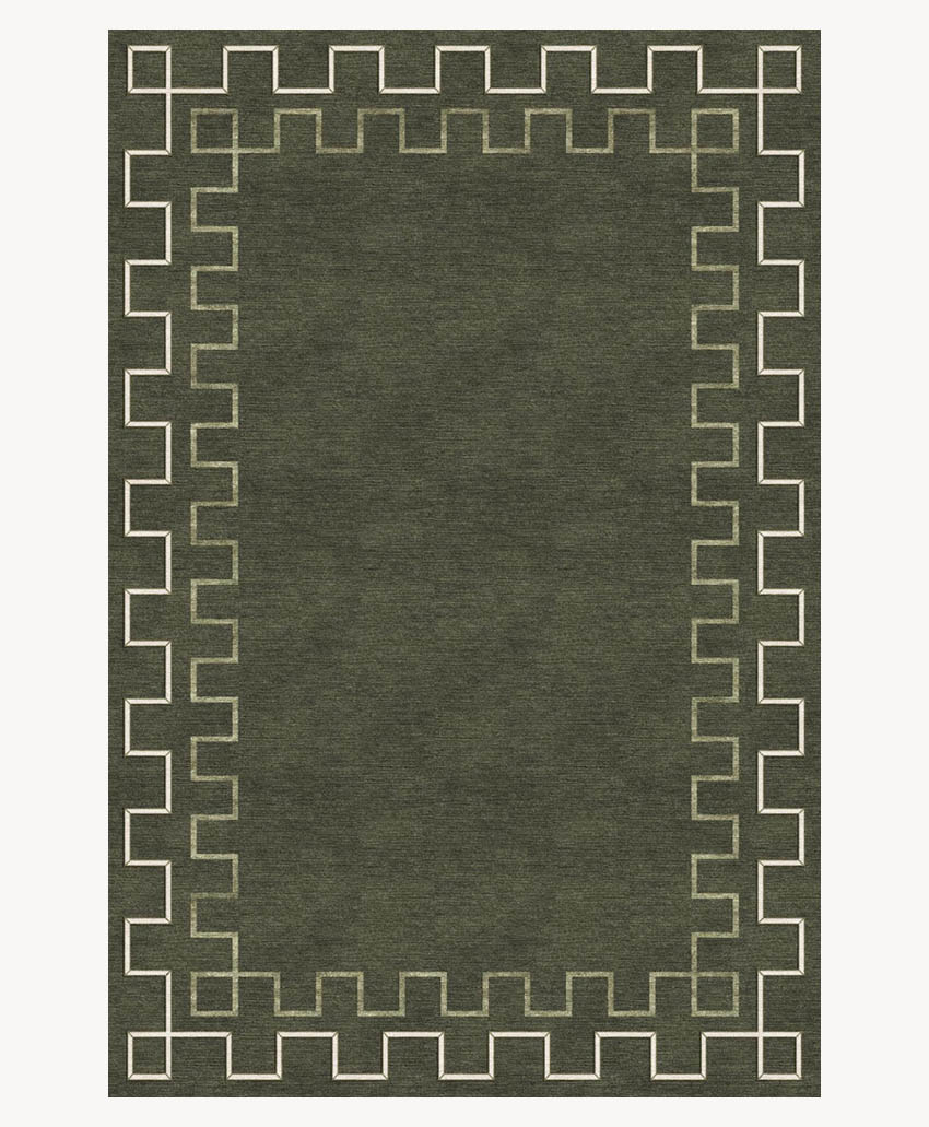 A dark green rectangular rug with a geometric Greek key border pattern in light beige, creating a bold, symmetrical frame around the solid-colored center.