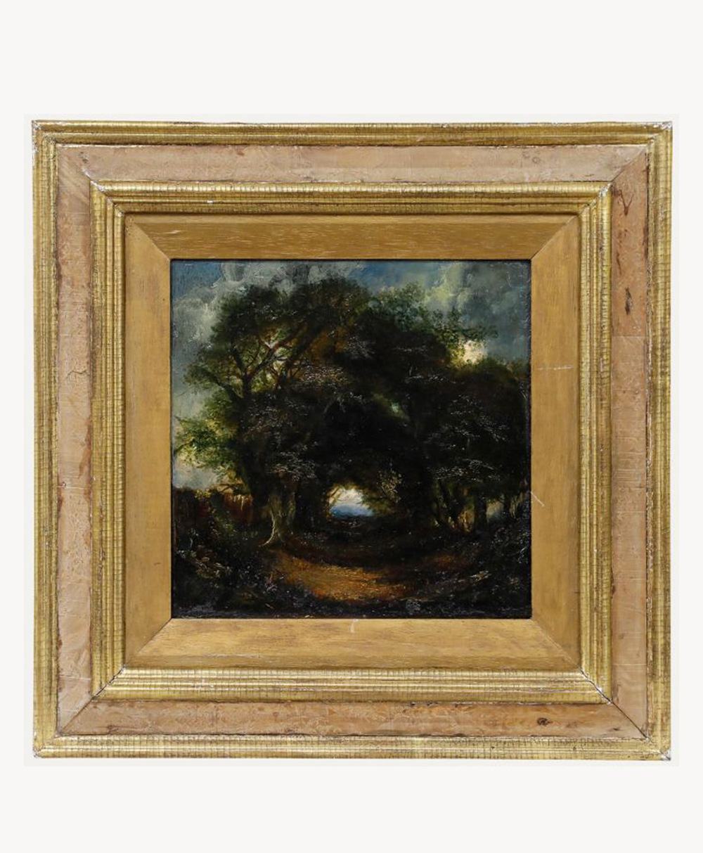 A framed painting depicts a dark, wooded path under a cloudy sky, with dense trees arching over a dirt walkway. The ornate gold frame surrounds the moody landscape scene.