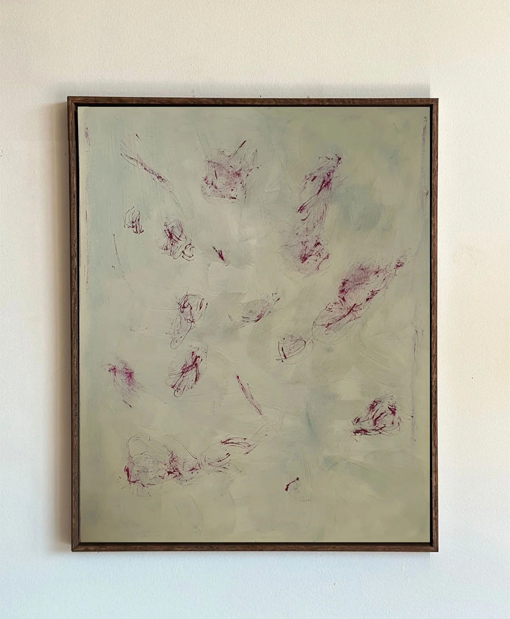 A framed abstract painting with a pale, muted background and scattered brushstrokes of deep red and purple, creating a minimalist and textured composition. The painting hangs on a plain white wall.