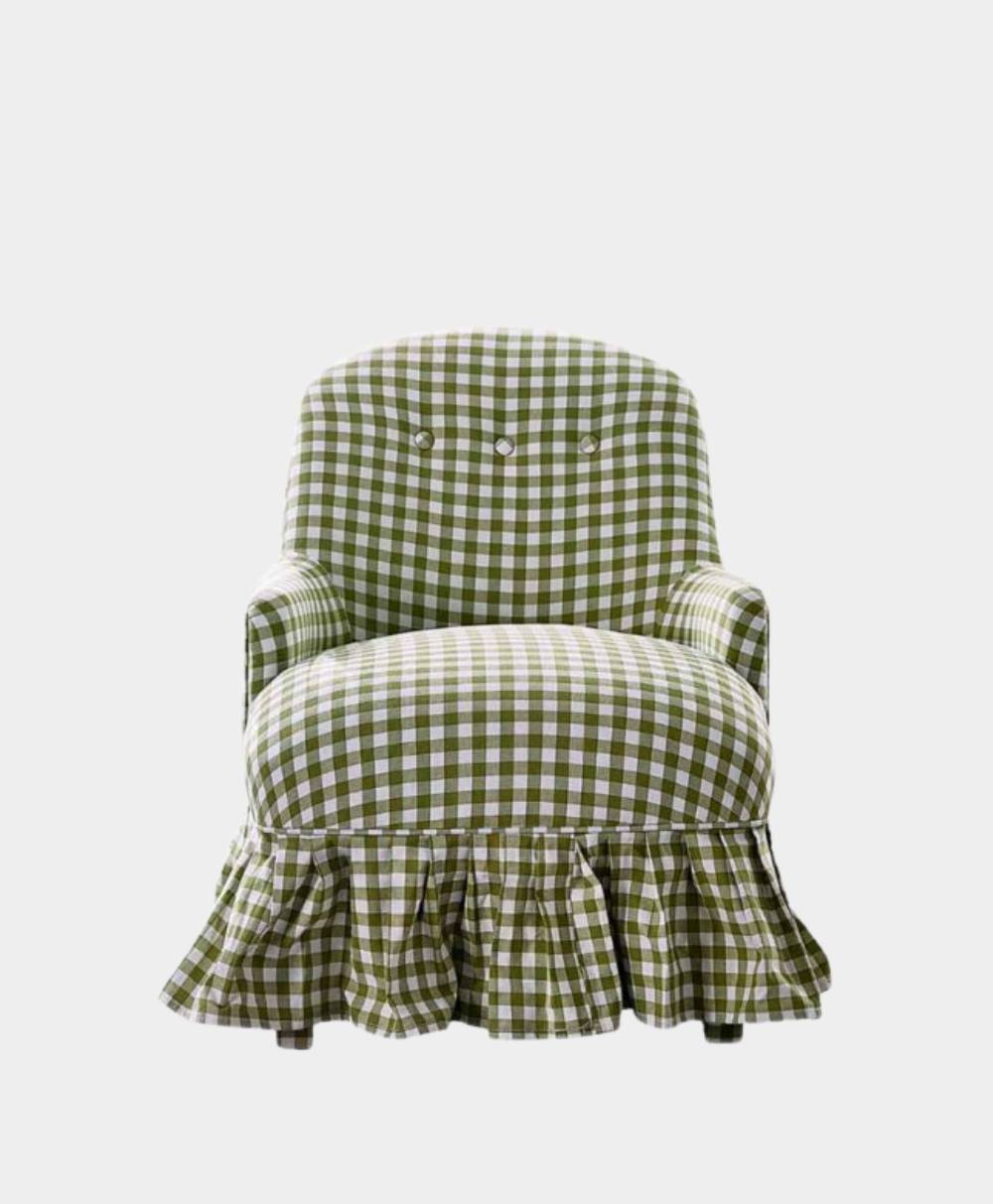 A green and white gingham armchair with a ruffled skirt, set against a plain white background.