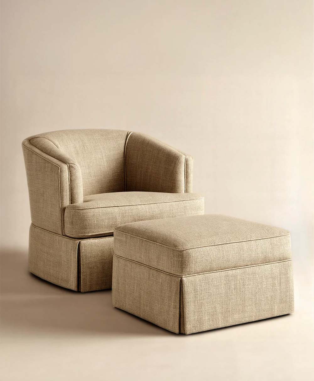 A beige upholstered barrel chair with matching square ottoman, both featuring a skirted base and clean, modern lines, set against a neutral background.