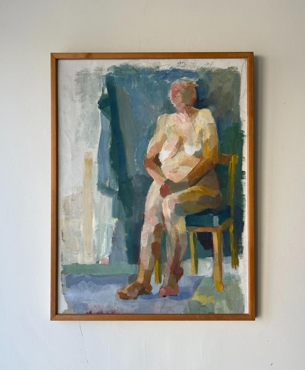 A framed painting depicts an abstract, nude person sitting on a yellow chair against a muted background with blue, green, and beige tones. The figures features are indistinct, emphasizing form over detail.