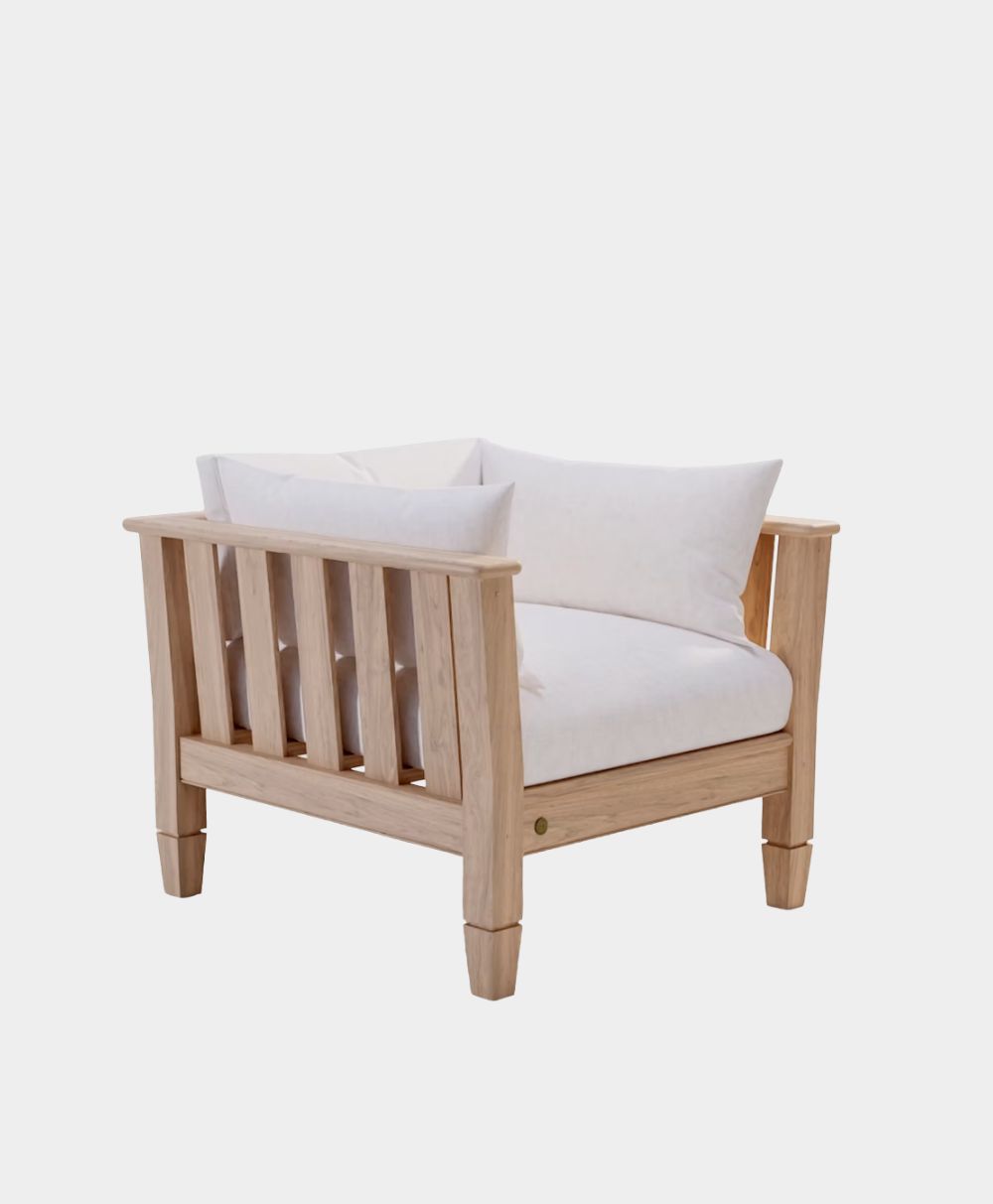 A modern wooden armchair with light-colored wood, featuring vertical slats on the sides and back, and white seat and back cushions.