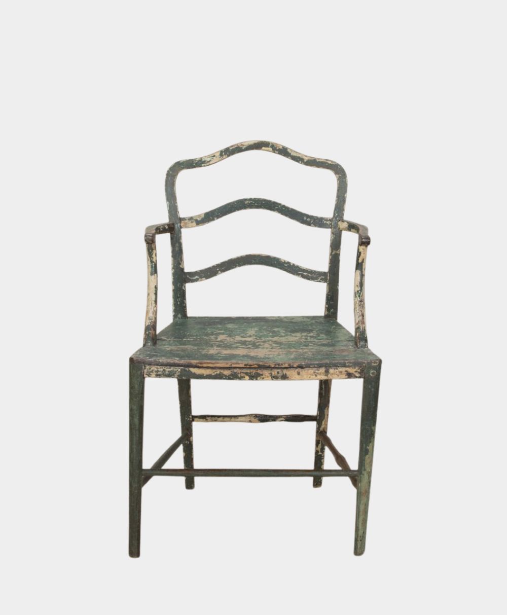 A worn, vintage wooden chair with curved back slats and armrests, painted green with areas of paint chipped away, revealing the wood underneath. The chair is photographed against a plain white background.