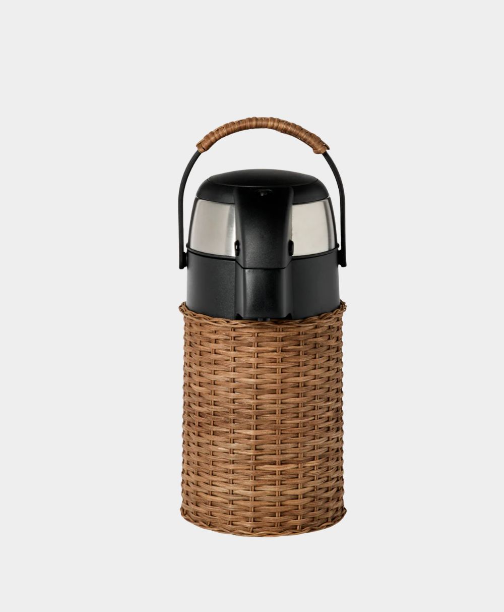 A black and silver thermos with a woven wicker cover and a matching wicker handle, set against a plain light gray background.