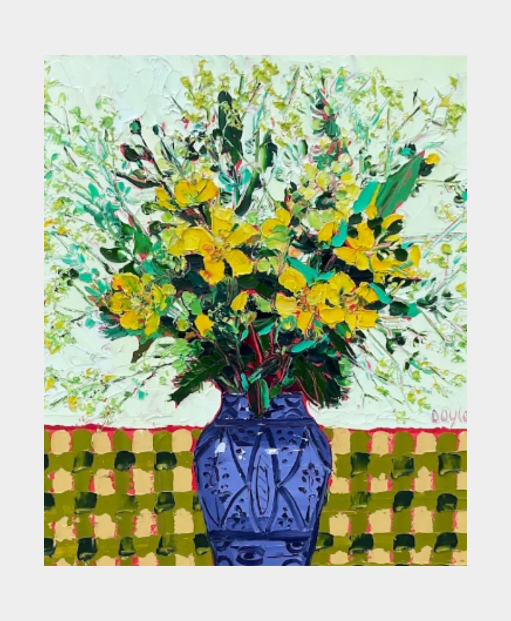 A blue vase holding a bouquet of vibrant yellow flowers sits on a green and yellow checkered tablecloth, with a textured, light-colored background.