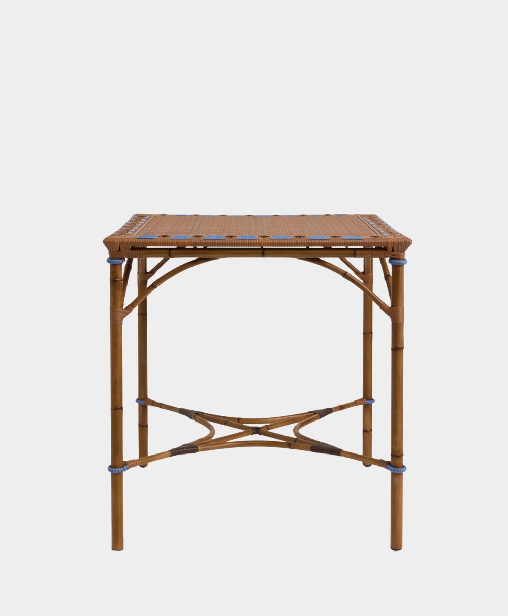 A square rattan side table with a woven top and crossed support bars connecting the four legs, set against a plain white background.