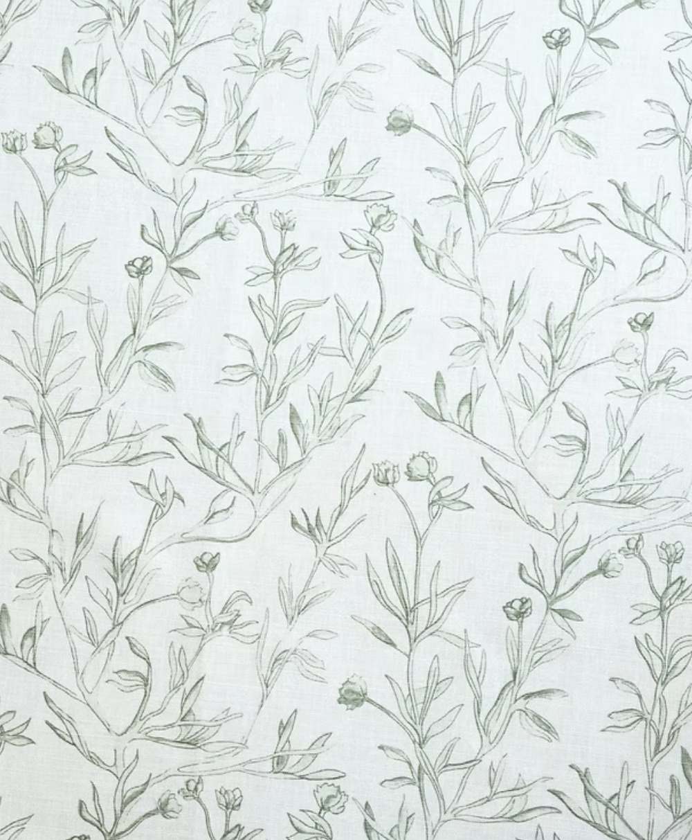 Light fabric with a subtle, hand-drawn green botanical pattern featuring delicate leaves and small flowers scattered across a white background.
