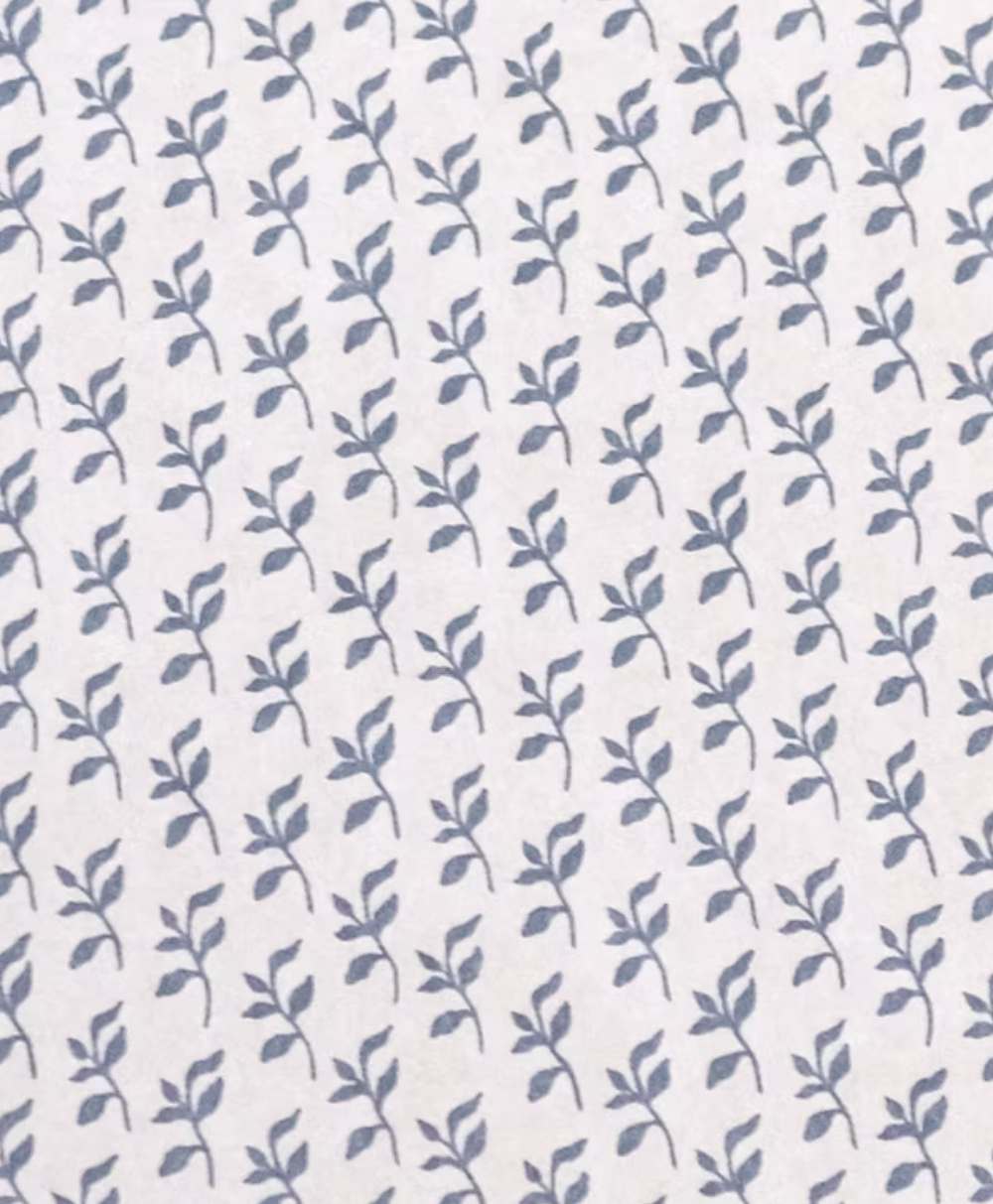 A repeating pattern of small blue leafy branches on a white background. The simple, uniform botanical design creates a subtle and elegant look.