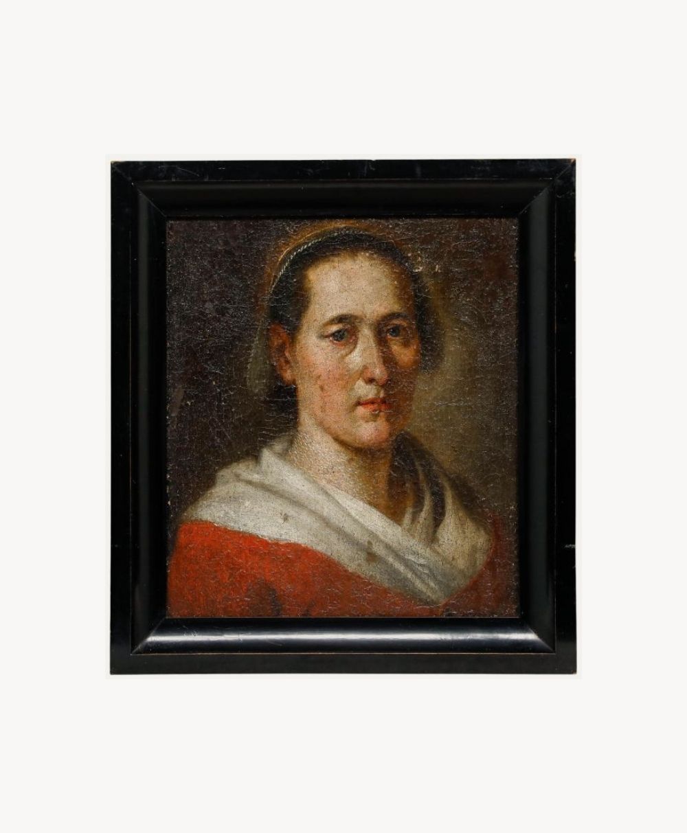 A classical oil painting of a person with short hair, wearing a red garment and a white shawl, set against a dark background and framed in a black frame.
