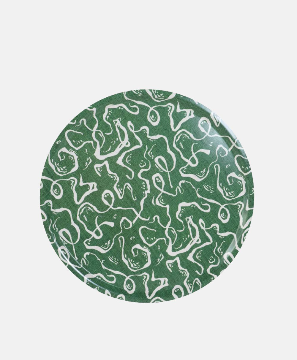 A round plate with a green background featuring an abstract white squiggly line pattern covering the entire surface.