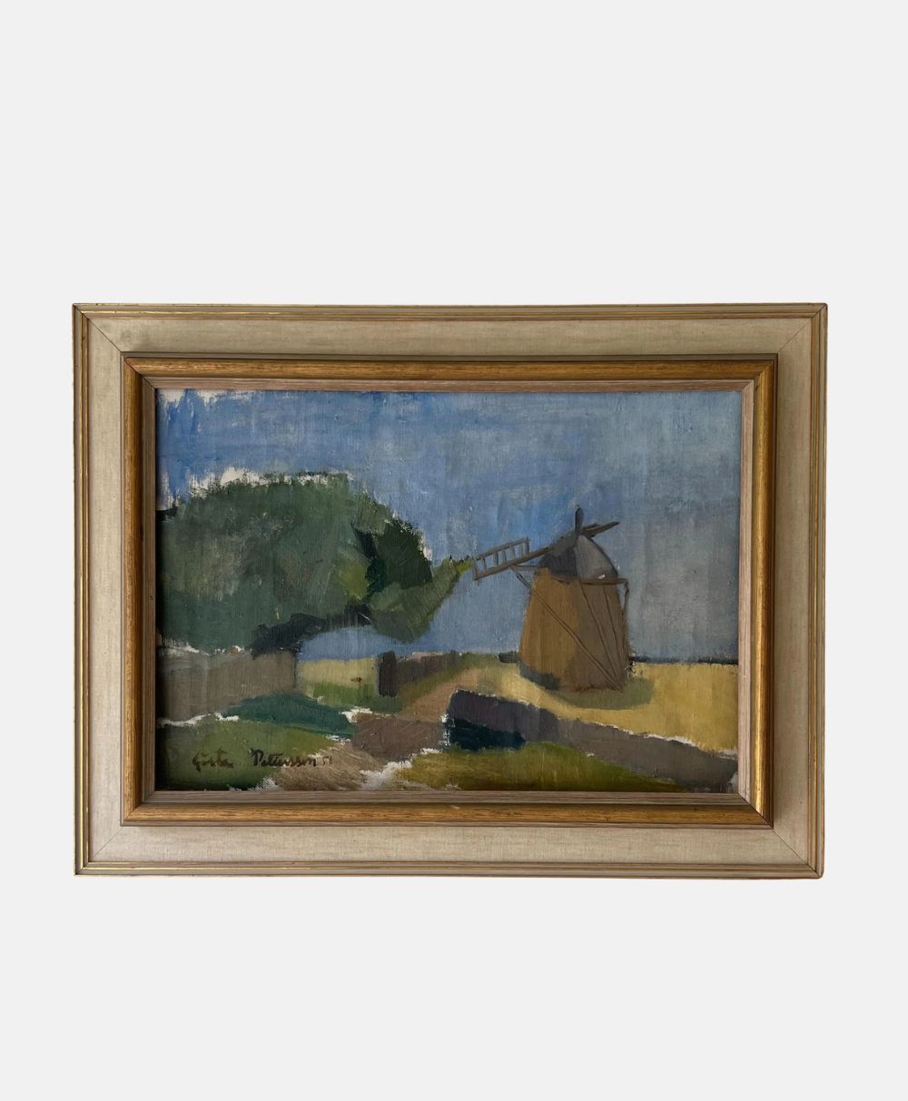 Framed painting of a rural landscape featuring a windmill, a dirt path, green trees, and yellow fields under a blue and gray sky. The artwork has an impressionistic style.