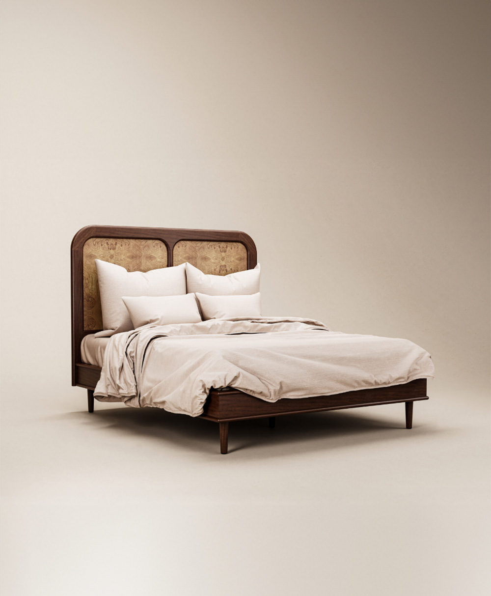 A neatly made wooden bed with a tall headboard, beige bedding, and several white pillows, set against a plain light background.