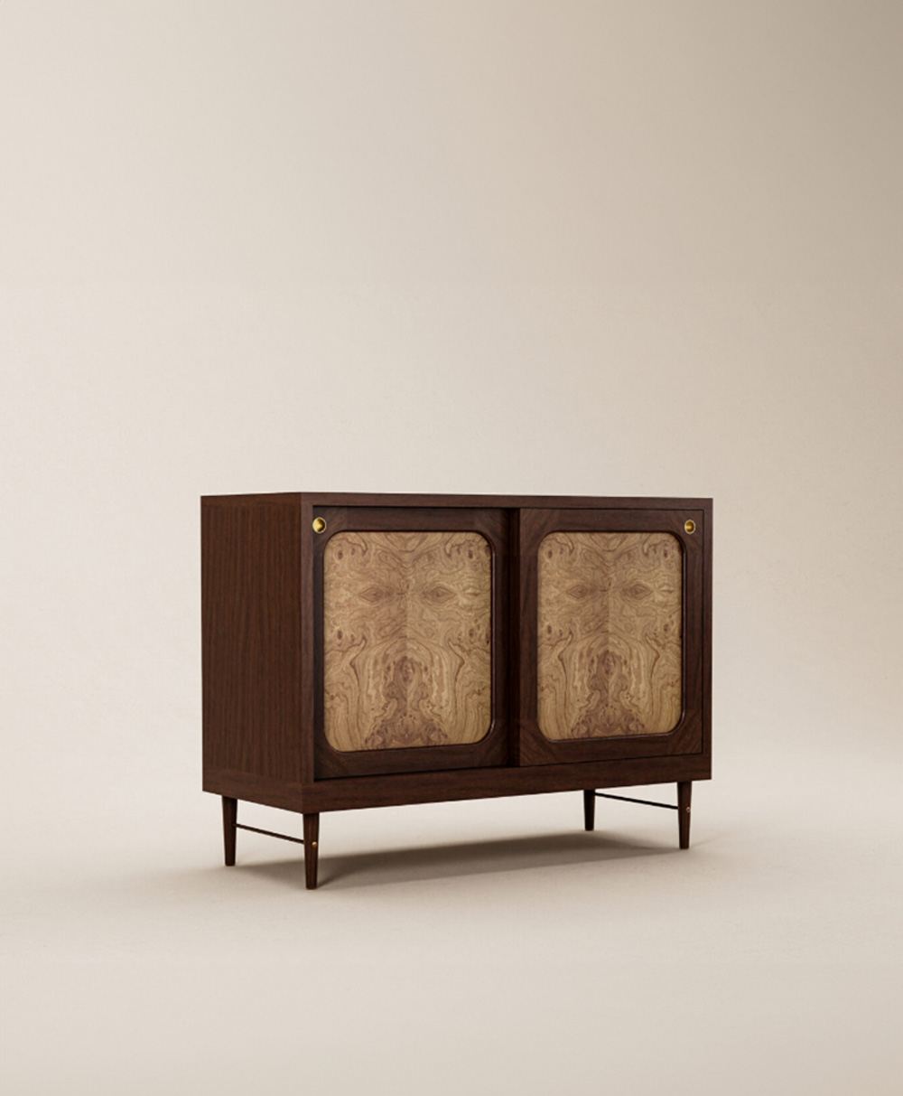 A mid-century modern wooden cabinet with dark wood frame, tapered legs, and two front doors featuring lighter wood panels with a unique, natural grain pattern. The cabinet is set against a plain beige background.