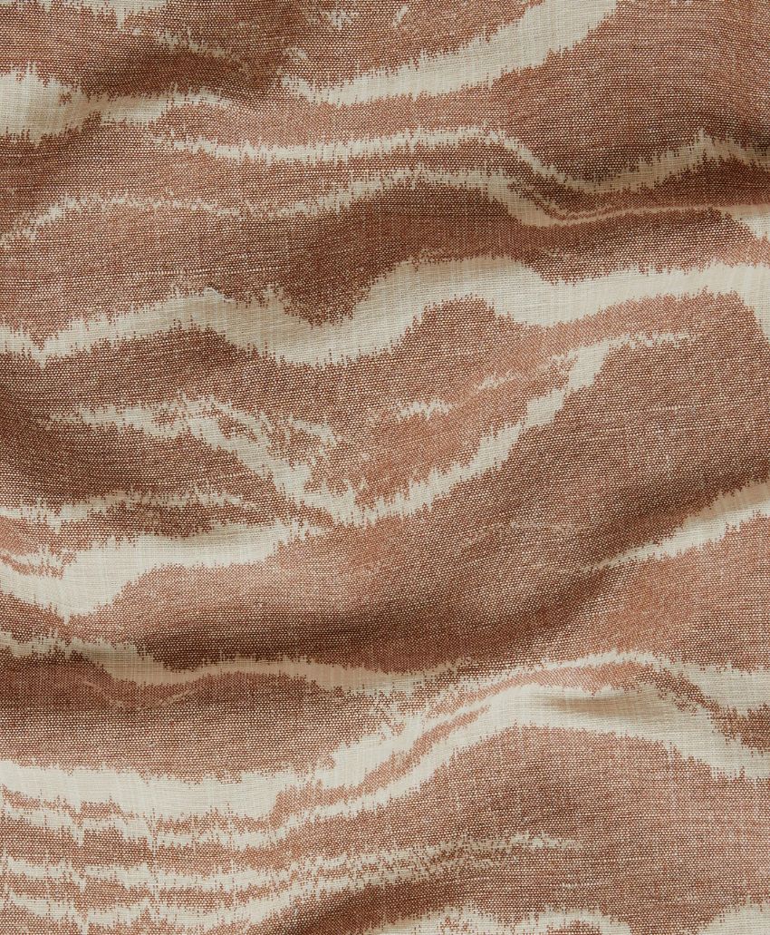 Textured fabric with a wavy, abstract pattern in shades of brown and beige, resembling natural wood grain or topographic lines. The surface appears slightly wrinkled.