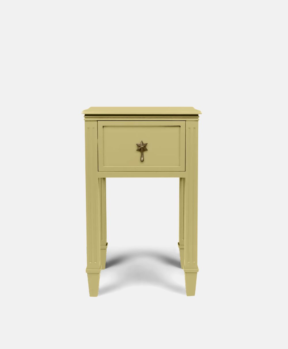 A small, light yellow nightstand with one drawer featuring a star-shaped handle, standing on four straight legs against a plain white background.
