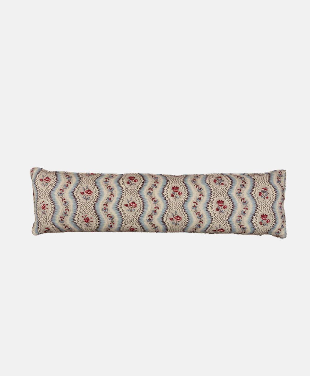Rectangular decorative bolster pillow with a wavy, multicolored pattern featuring red floral motifs on a light background.