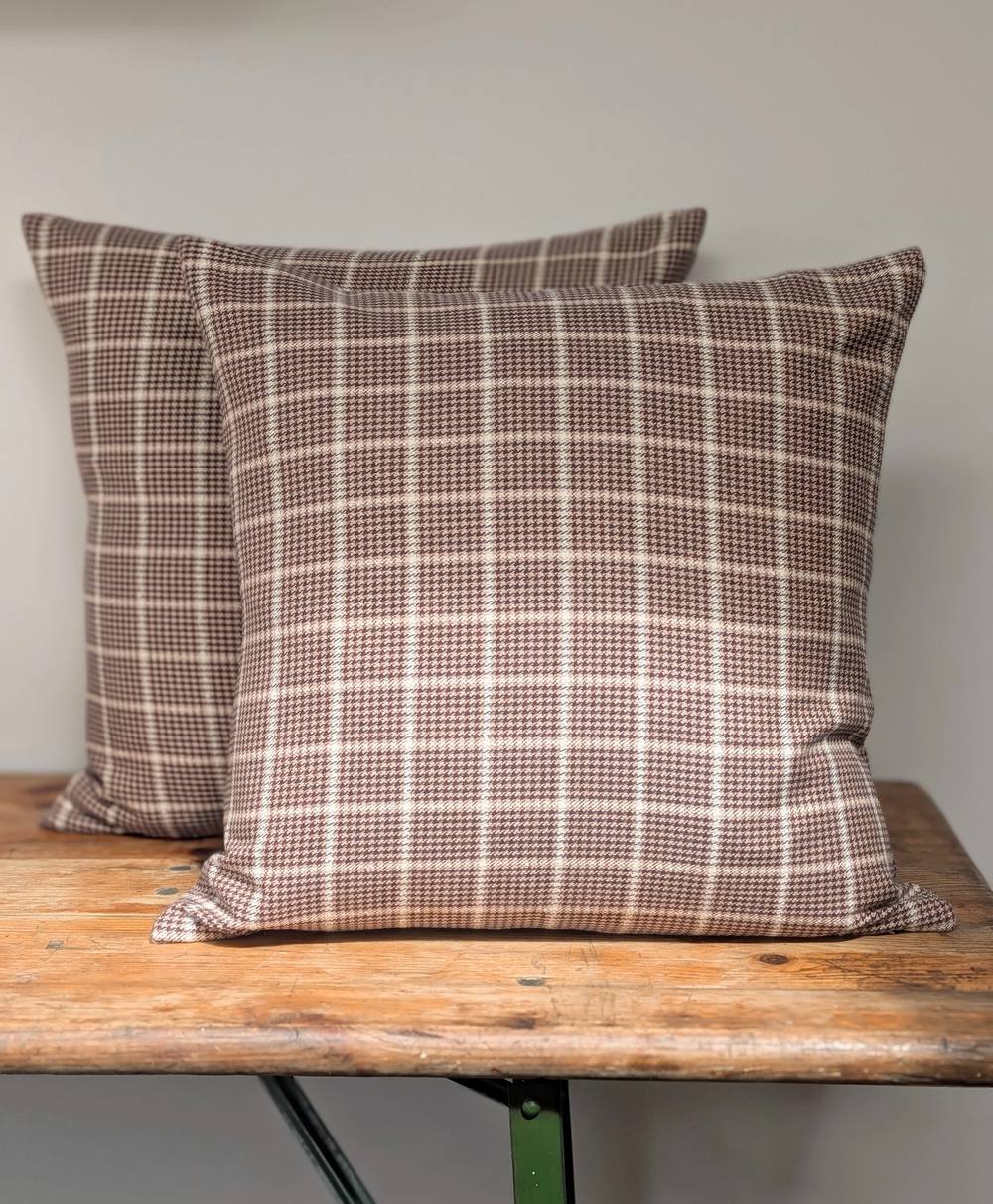 Katherine Fraser Sienna Silk Cotton Cushion sat on a wooden bench - Scheme
