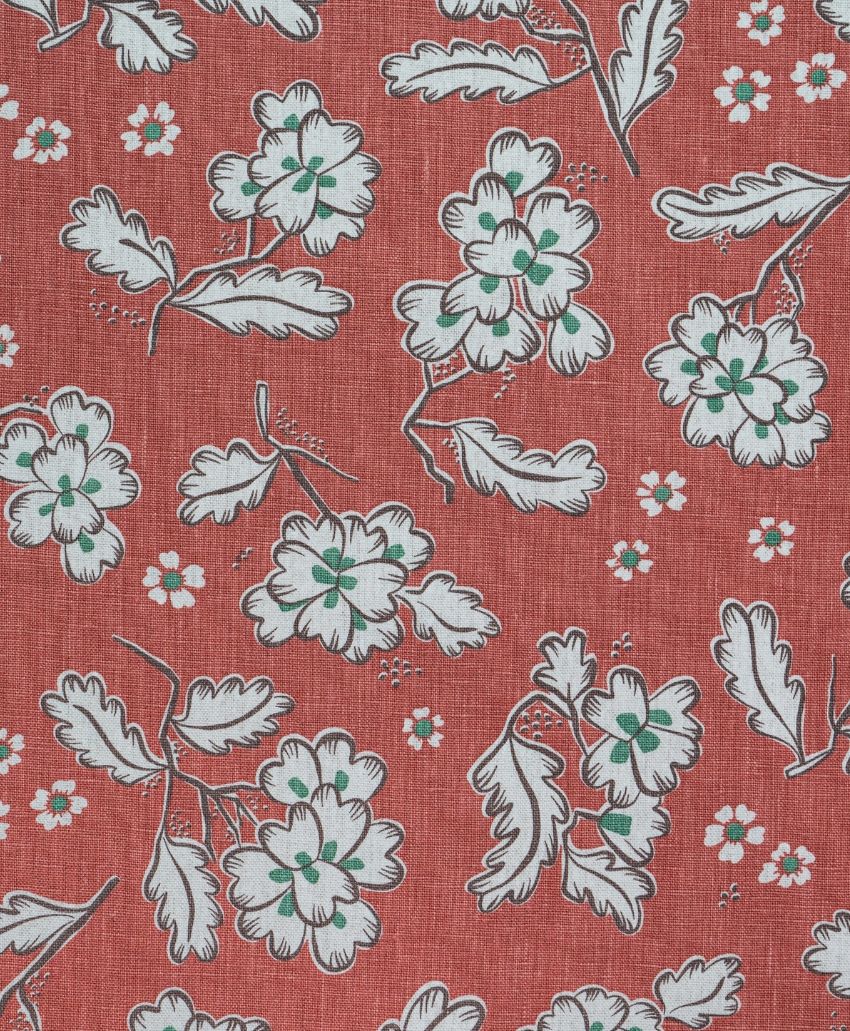 Cathy Nordström Ingrid fabric in Desher Red, a linen with a pale blue and green floral and leaf print on a brick red ground
