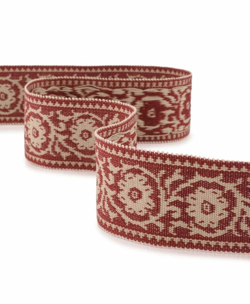 Inchyra Labeaume Braid trim in Cherrywood, a woven red and cream braid with a floral medallion pattern, shown in a loose curve