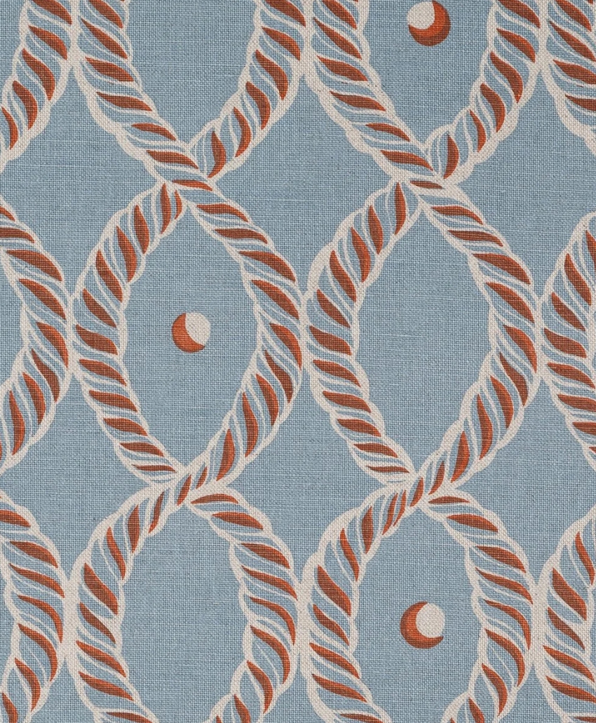 Bold geometric fabric featuring interlocking circular motifs in field blue and rust by Beki Bright. Scheme, UK
