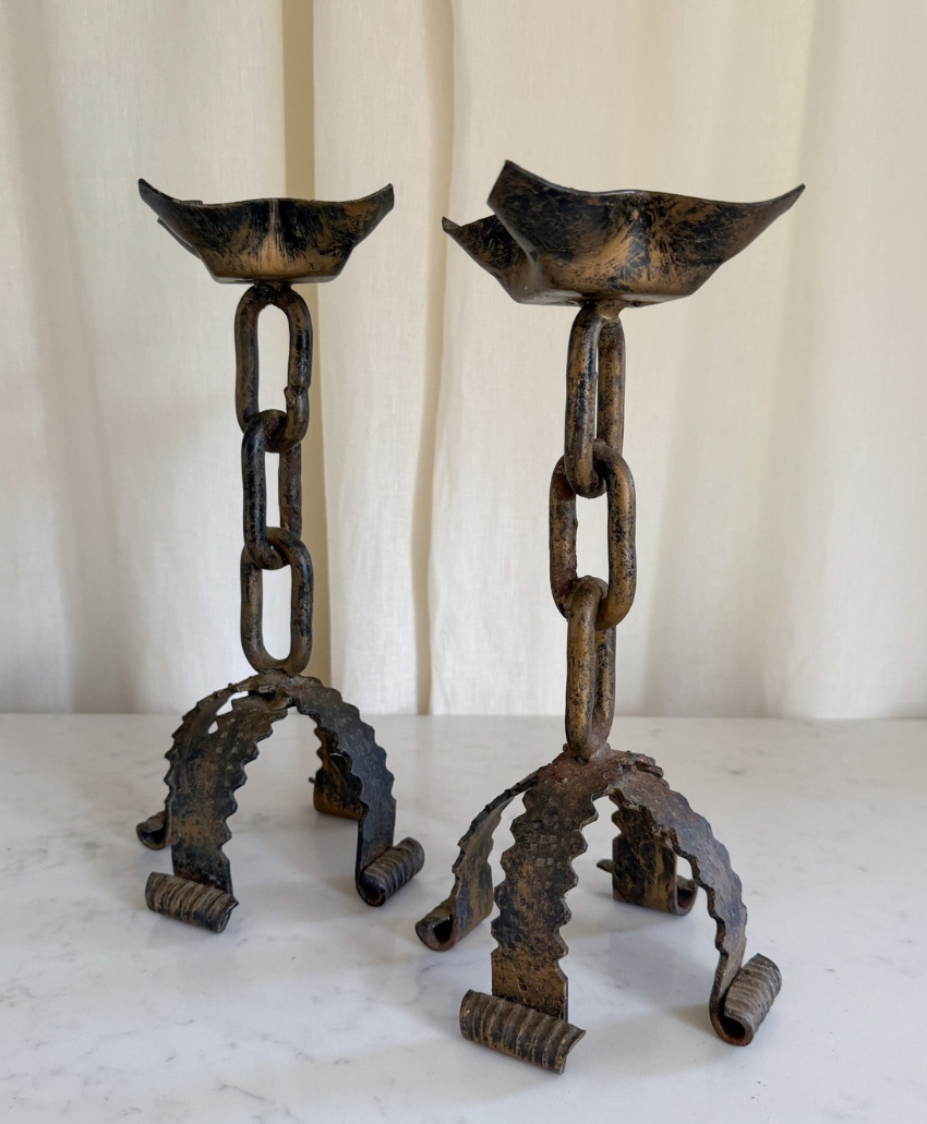 Fern & Green A Pair of Large Brutalist Mid-Century Wrought Iron Chain Candlesticks in Metallics, UK, Scheme Interior, a pair of sculptural iron candlesticks with chain-like detailing.