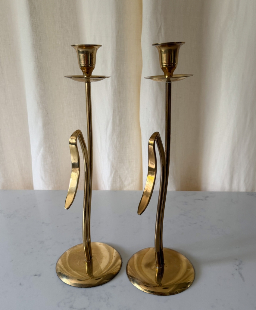 Fern & Green A Pair of Tall Mid-Century Brass Candlesticks in Brass, UK, Scheme Interior, a pair of tall vintage candlesticks with a warm metallic finish.