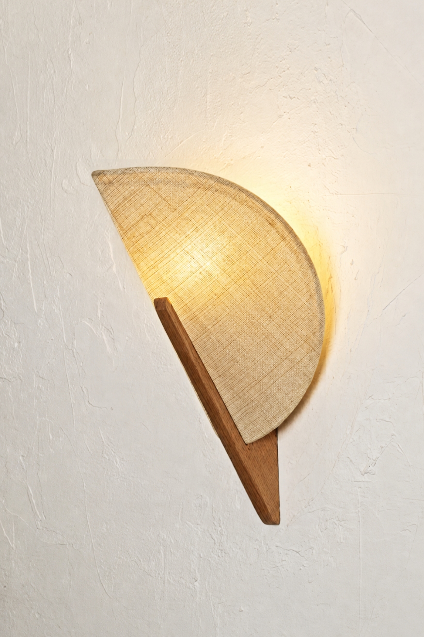 Makai Wall Light by Fosbery Studio, featuring a curved natural fibre shade and wooden detailing, shown illuminated and unlit, Scheme, UK