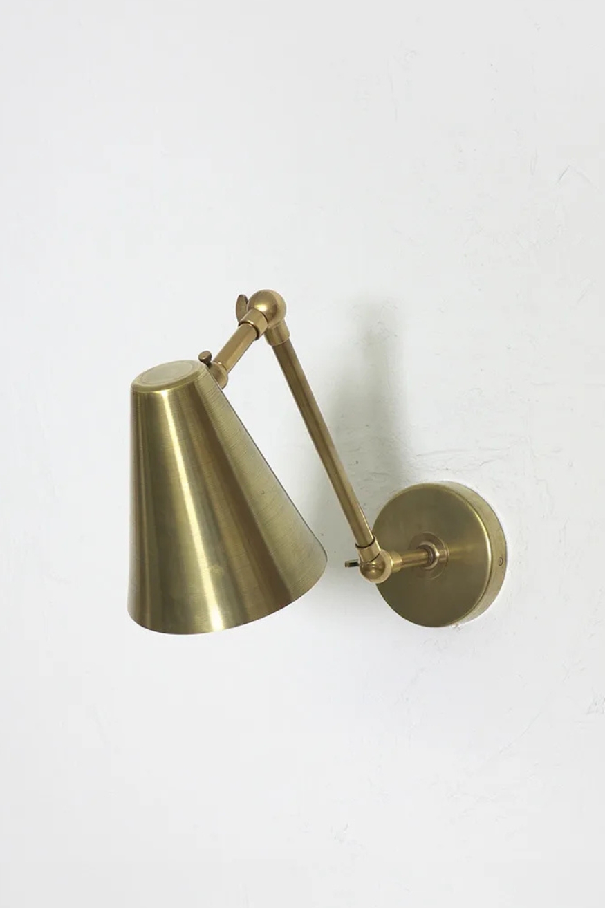 Brass adjustable wall light with a conical shade and articulated arm by Fosbery Studio, Scheme, UK