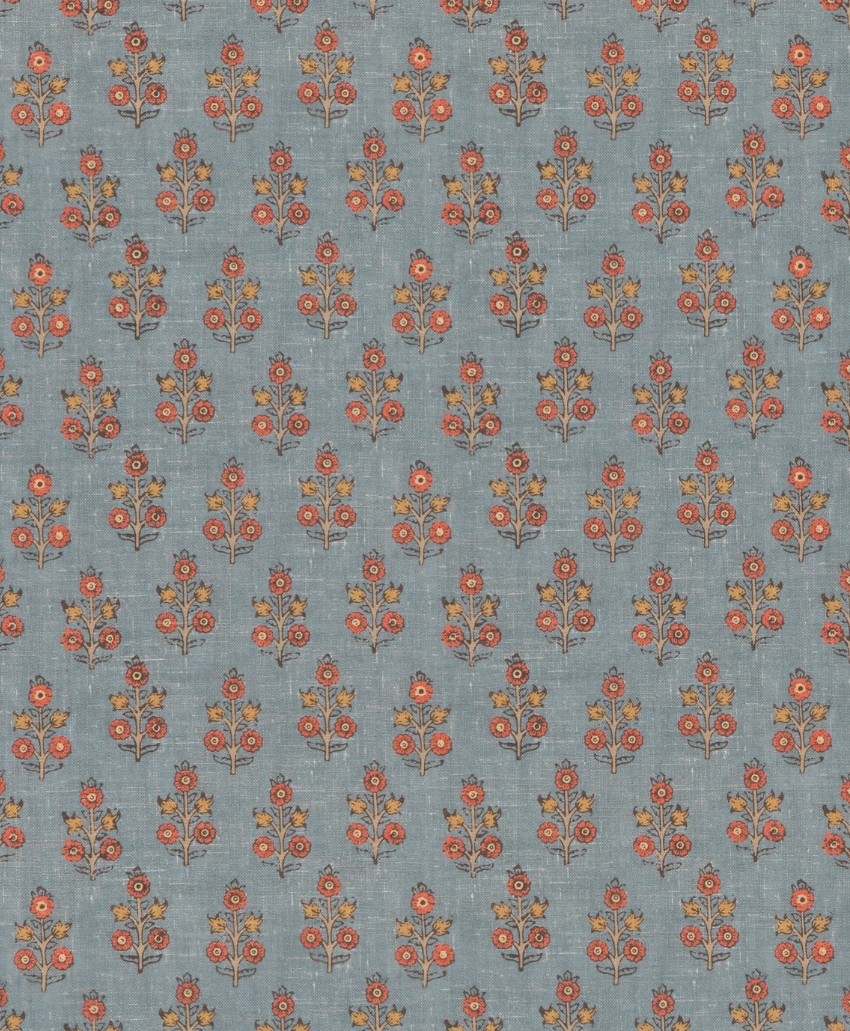 Delicate repeating floral sprig fabric in soft denim blue with warm pink accents by GP & J Baker. Scheme, UK